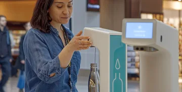 Woman refilling water bottle at airport